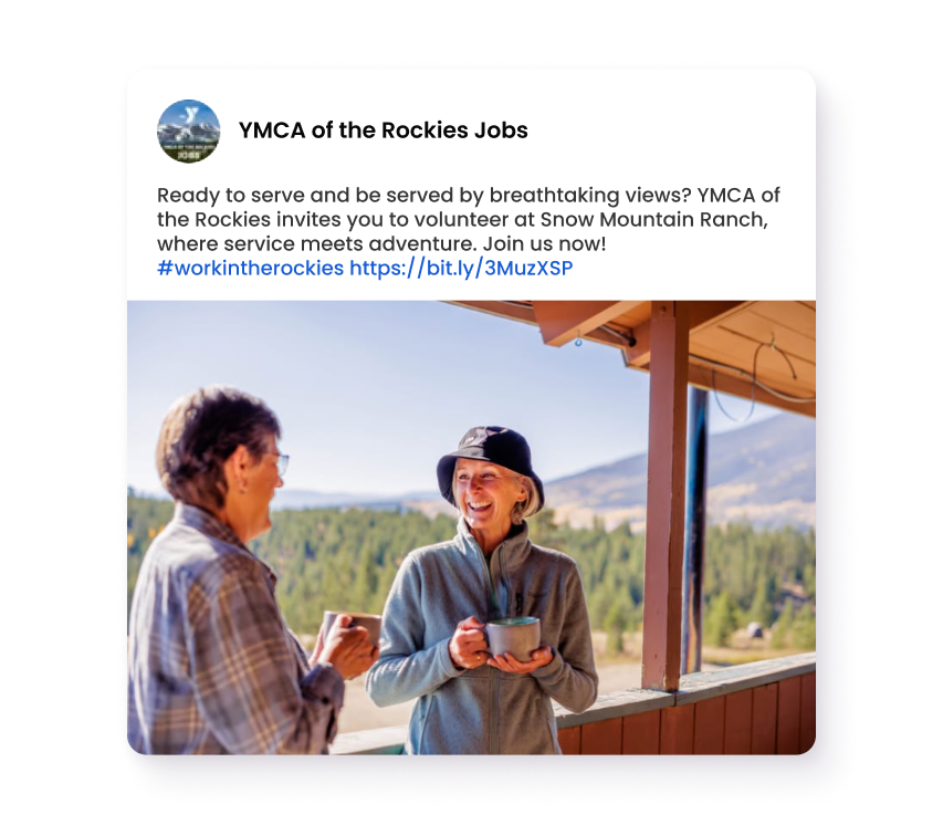Work and Volunteer at YMCA of the Rockies Two people smiling and holding mugs on a scenic mountain lodge porch
